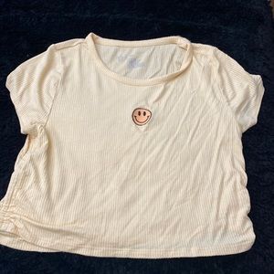 Selling a yellow crop top with a smiley face on it